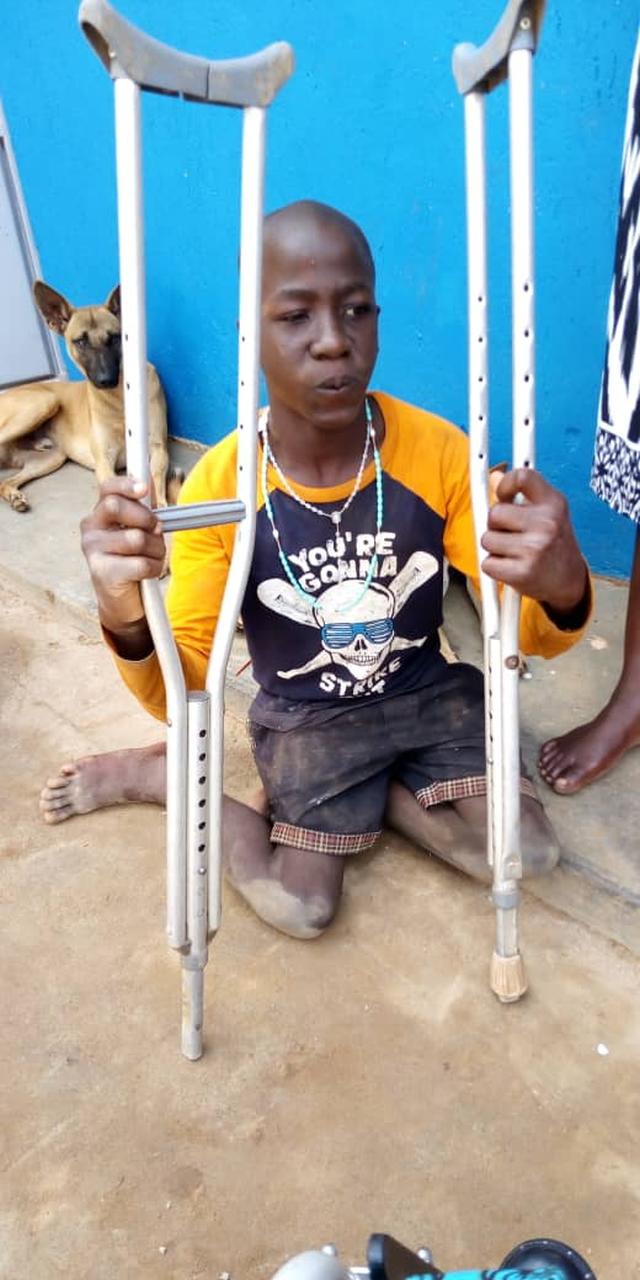 Wasswa with his new gift of crutches.