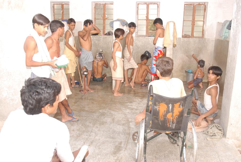 Children performing their morning chores in en suite bathrooms, constructed specifically for the severely disabled