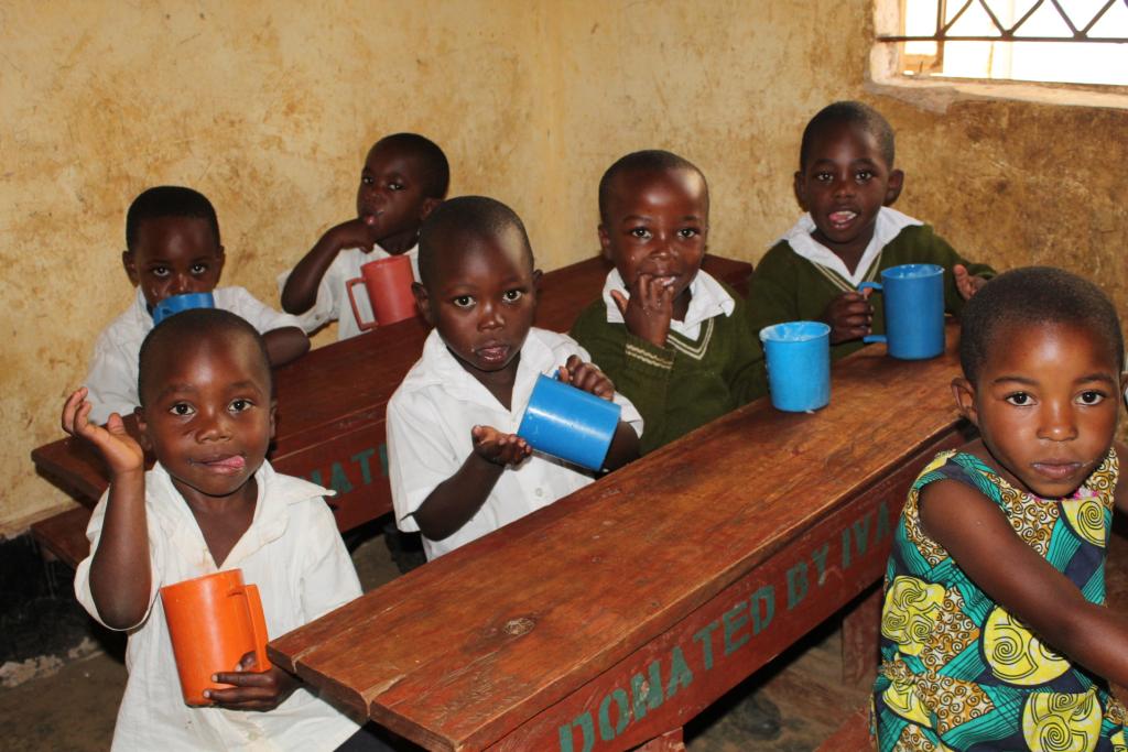 Children enjoying a mid-morning glass of milk in their classroom